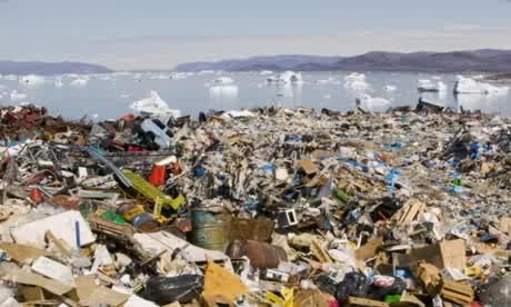 Rubbish dumped on the tundra outside llulissat in Greenland stand in stark contrast to icebergs.